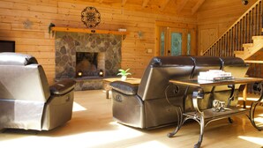 A wooden interior with a stone fireplace, leather recliners, and a wooden table with glasses. - A Slice of Salisbury, Pool,Hot Tub, 10 acres (Salisbury)
