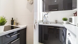 A modern kitchen with a built-in oven, a microwave, and a dishwasher.