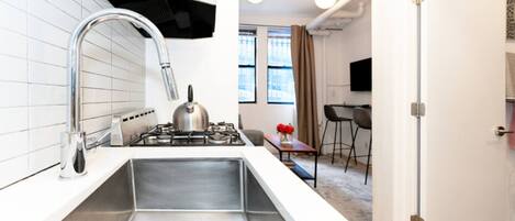 Fridge, stovetop, dishwasher, coffee/tea maker