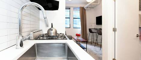 Fridge, stovetop, dishwasher, coffee/tea maker