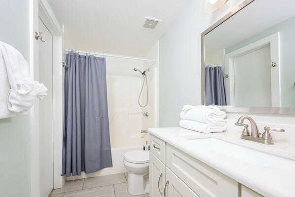 A bathroom with a shower, toilet, and sink. - Phoenix X 808 Gulf Front 1 bedroom (Orange Beach)