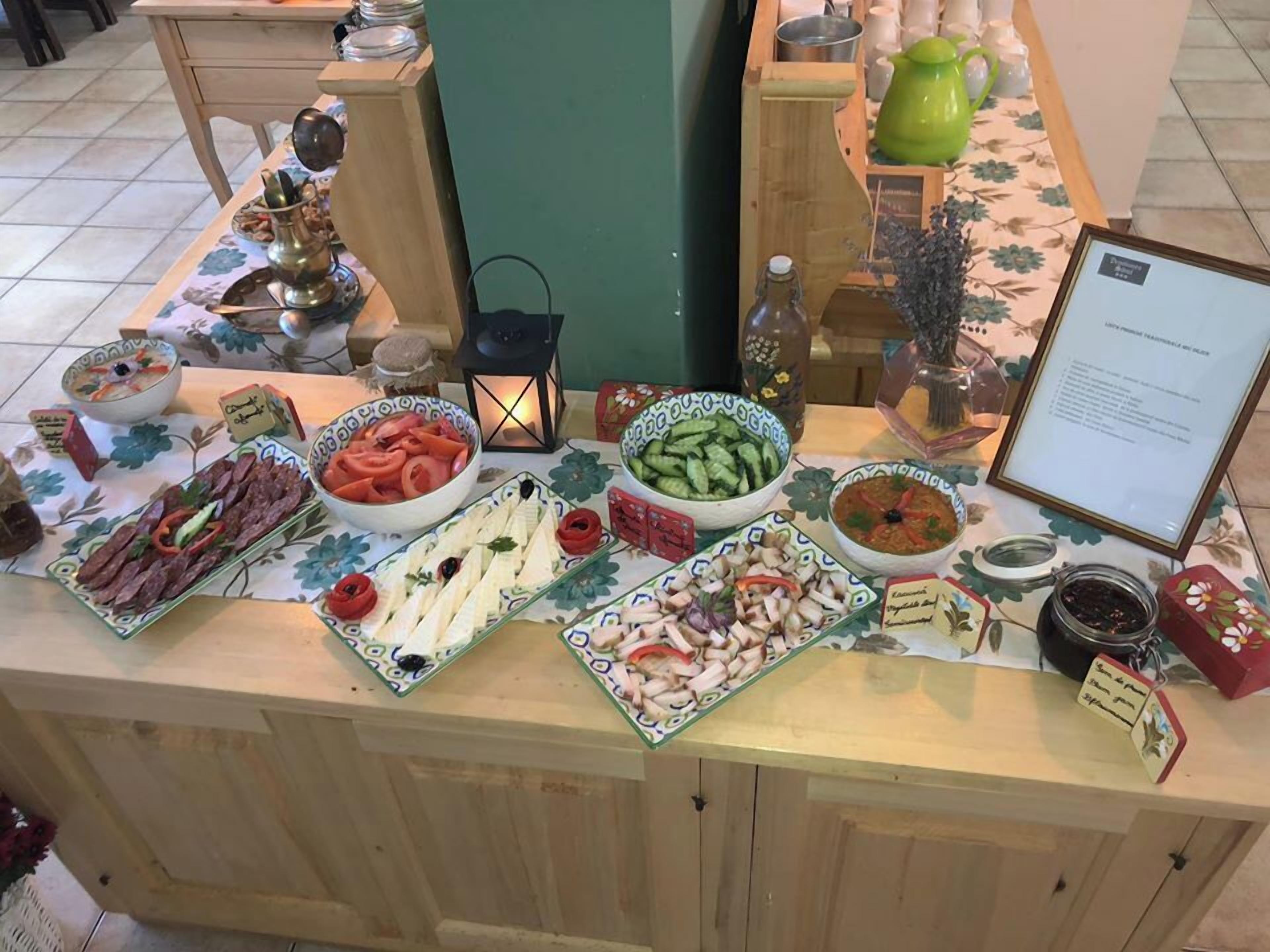 A buffet table with various dishes and condiments.