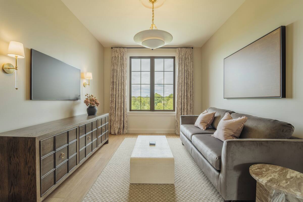 A modern living room with a sofa, coffee table, and a cabinet.