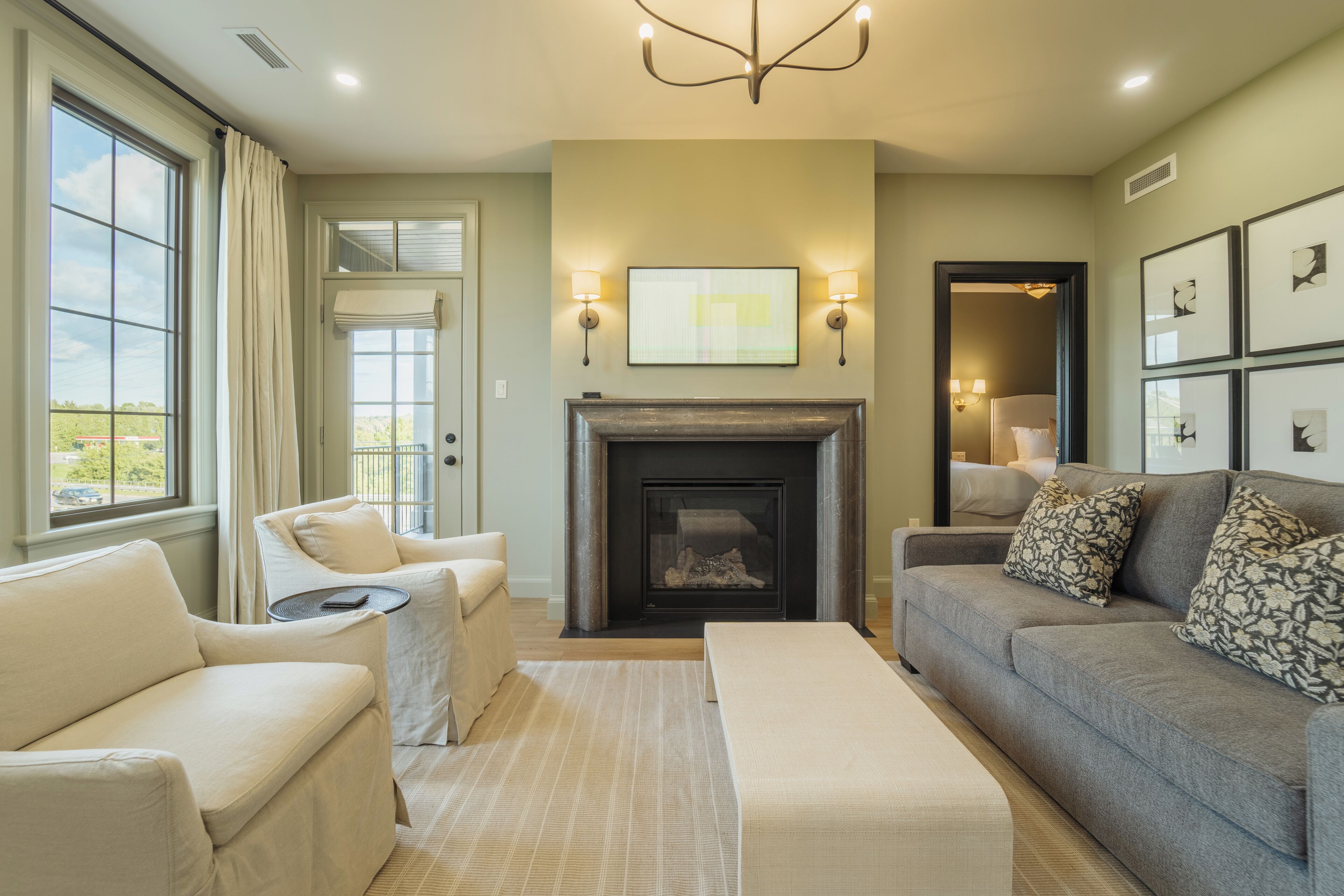 A living room with a fireplace, a sofa, a chair, and a coffee table.