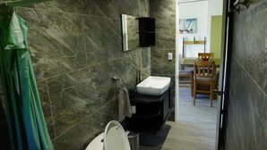 A bathroom with a white sink, a mirror, and a toilet. - Fully equipped 2-bedroom apartment close to mountains and beach with great WiFi (Playa Hermosa)