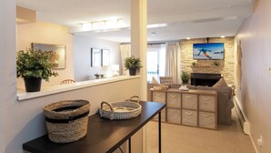 A modern living room with a fireplace, a television mounted on the wall, and a comfortable seating area. - Beautifully, Cozy Condo, Steps from Complimentary Shuttle, Free parking (Vail)
