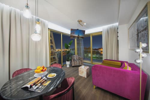 Luxury Suite with balcony and river view | Premium bedding, pillow-top beds, individually decorated