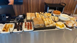 A buffet with various food items including pastries, bread, and desserts. - Salinas Exclusive Resort (Salinópolis)