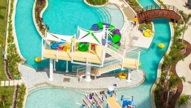 A water park with multiple slides and water play areas, surrounded by a pool and walkways. - Salinas Exclusive Resort (Salinópolis)