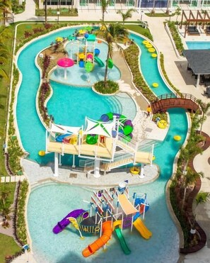 A water park with multiple slides and water play areas, surrounded by a pool and walkways. - Salinas Exclusive Resort (Salinópolis)