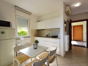 Enjoy meals in the kitchen with a microwave and refrigerator, and dine at the table with cushioned chairs.
