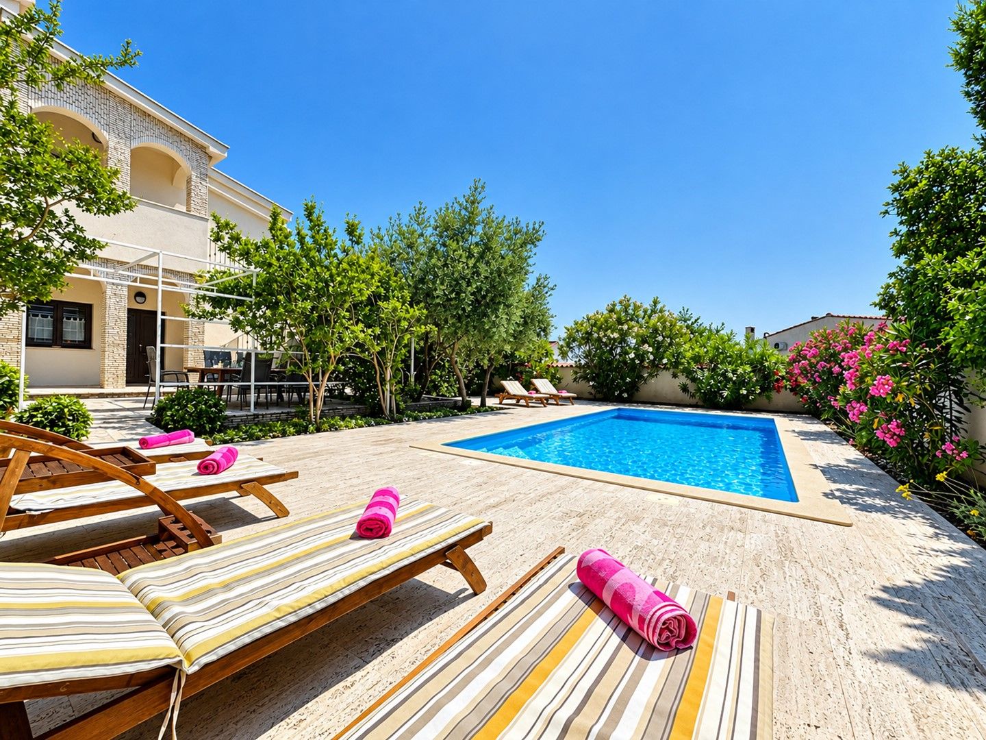 A poolside area with lounge chairs and a swimming pool.