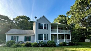 A two-story house with a front porch and a large lawn. - Summer Beach Rental w/ Beach Pass - 3 bed/3 bath (Charlestown)