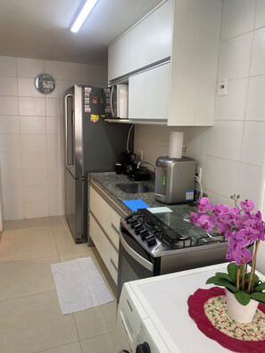 Enjoy cooking in this well-equipped kitchen with a gas stove, microwave, and refrigerator.