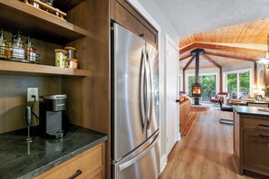 Well-equipped kitchen with coffee station, generous storage, and open area