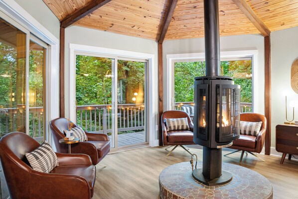 A quiet corner to curl up, read, or enjoy the fire surrounded by trees.