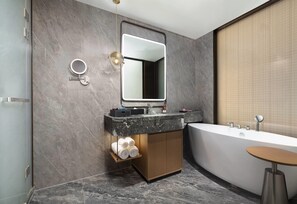 A modern bathroom with a freestanding bathtub, a vanity with a mirror, and a towel rack. - Days Hotel by Wyndham Hefei Huaihe Road Walking Street (Hefei)