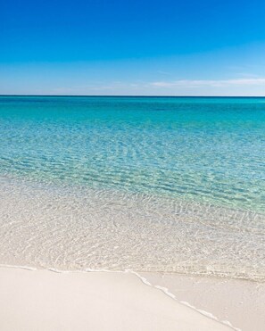 A beach with clear turquoise water and white sand. - Ocean Breeze and the 19th Hole.  Your home away from home for BEACH and GOLF (Pensacola)