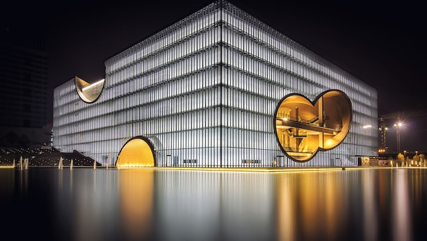 A modern building with a grid-like facade and large circular openings. - Hilton Garden Inn Shanghai Jiading (Shanghai)