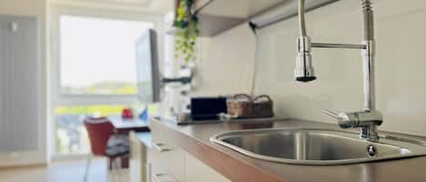 Fridge, stovetop, dishwasher, coffee/tea maker