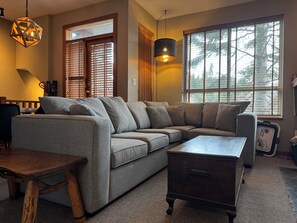 Relax in this inviting space with a comfortable sectional sofa and a coffee table.