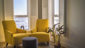 A room with two yellow armchairs, a small ottoman, and a potted plant. - Wight Stone Luxury Townhouse - Breathtaking Views  (Sandown)