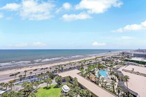 A coastal hotel with a swimming pool, beach access, and a view of the ocean.