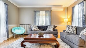 A living room with a sofa set, a coffee table, a patterned rug, and a chair. - Ski, Hike & Fish: Modern Rutland Home (Rutland)