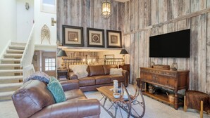 A living room with a brown leather sofa, a wooden coffee table, and a television mounted on a wooden wall. - Vail Vista Mountain Retreat w/ Balcony & Views, Near Vail Ski Village (Vail)