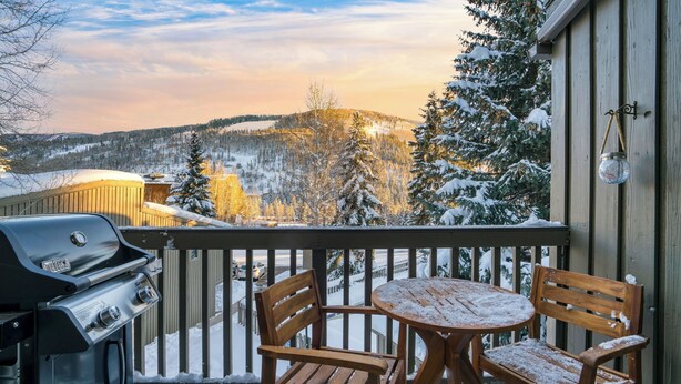A balcony with a grill, wooden chairs, and a table. - Vail Vista Mountain Retreat w/ Balcony & Views, Near Vail Ski Village (Vail)