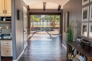 Stroll through the hallway to a serene patio area with a garden view.