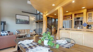 A modern kitchen with wooden cabinets, a stainless steel refrigerator, and a built-in oven. - Deck Views, Fire Pit, Pool, 3 Mins to Beach Madrona Tree Retreat by Avantstay (Coupeville)
