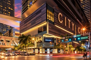 A modern hotel with a prominent 'CITY' sign, located at SW 8 St and S Miami Ave.