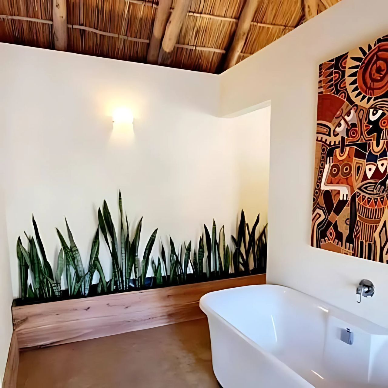 A bathroom with a white bathtub, a wall-mounted artwork, and a thatched ceiling.