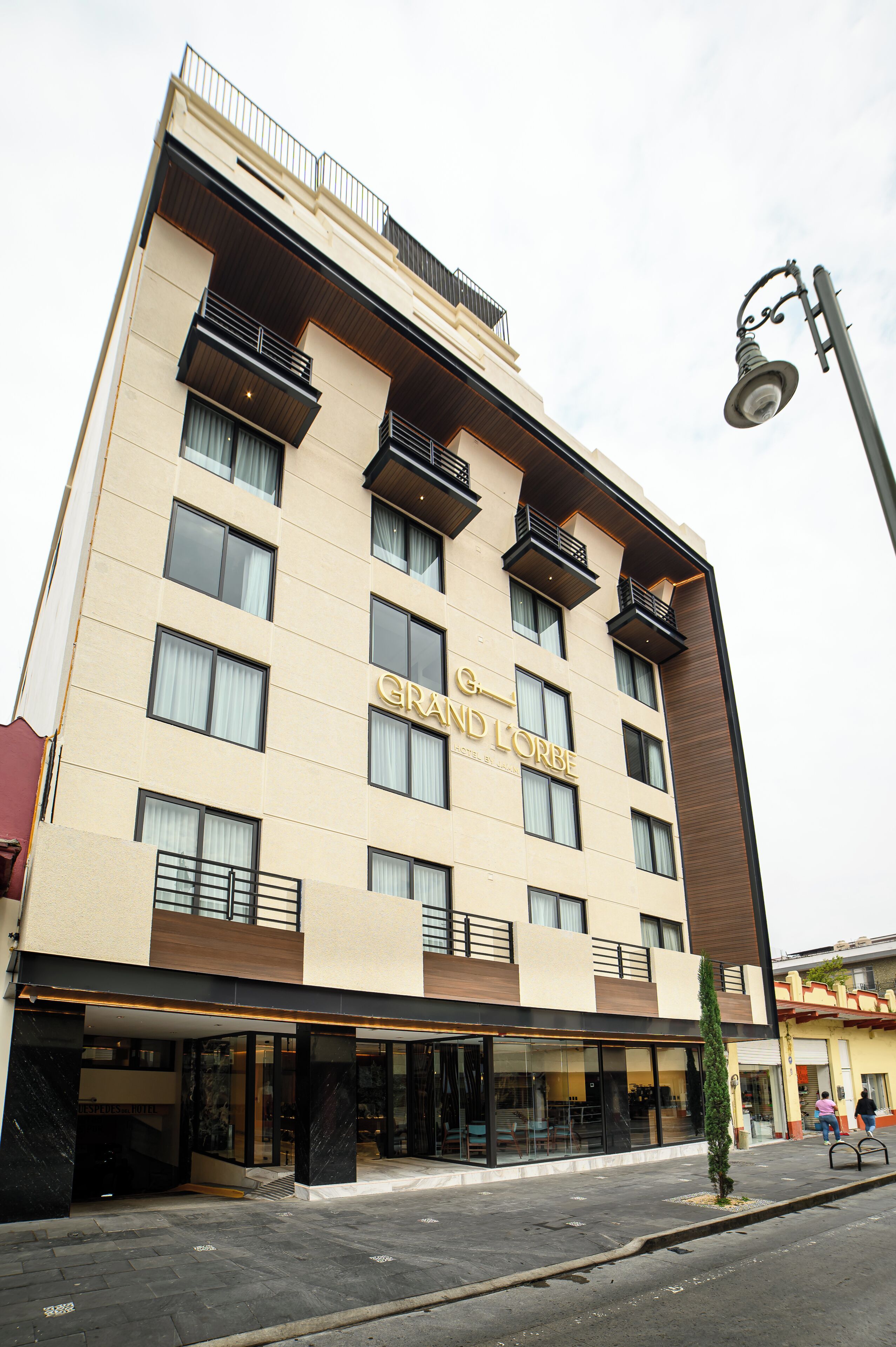 A multi-story hotel with a prominent sign reading "GRAND L'ORBE".