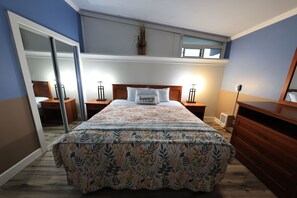 A bedroom with a bed, nightstands, a dresser, a mirror, and a ceiling light. - Beachwood Condos& Resort, Ocean Side Condo with 1 King Bed & Kitchen near beach (Copalis Beach)