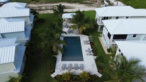 A residential area with multiple houses, a swimming pool, and surrounding greenery. - Treasure Cay Getaway with BOAT DOCK!
4 bedroom, pool, & bbq Cabana (Treasure Cay)