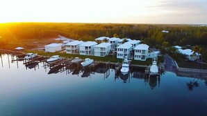 A waterfront property with multiple buildings, a marina with boats, and a reflection in the water. - Treasure Cay Getaway with BOAT DOCK!
4 bedroom, pool, & bbq Cabana (Treasure Cay)
