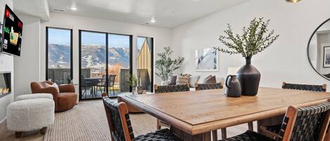 Enjoy meals in the dining area with a large table and comfortable seating, offering a view of the surrounding landscape.