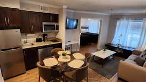 A compact living space with a kitchen, dining area, and a living room. - First Floor Family Disney Universal Orlando (Kissimmee)