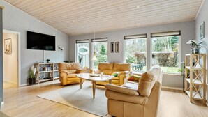A spacious living room with a wooden ceiling, large windows, and a modern sofa set. - Amazing home in Højslev with sauna (Højslev)
