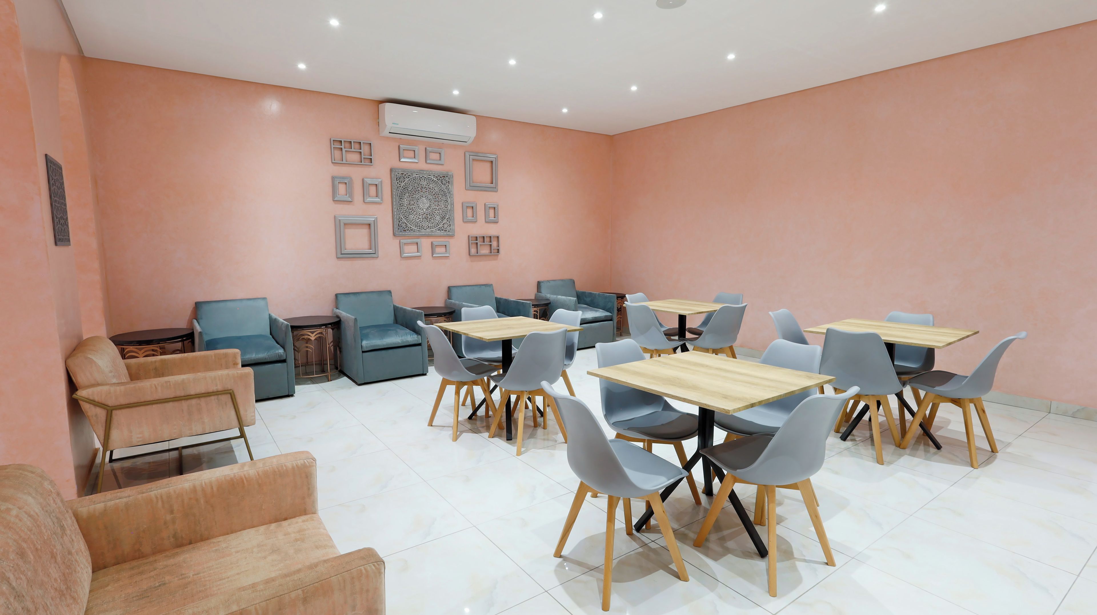 A modern dining area with sofas, tables, and chairs.