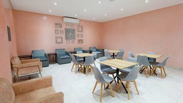 A modern dining area with sofas, tables, and chairs.