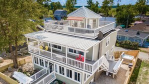 A multi-story house with a large deck, outdoor seating, and a hot tub. - Whirlwind Waters Paradise (Russells Point)