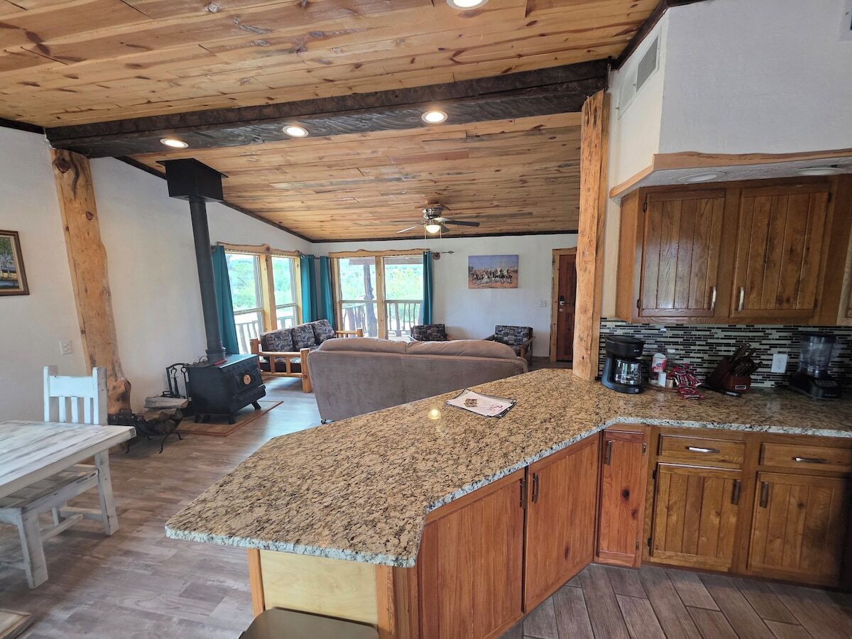 Full kitchen with gas range, stainless dishwasher, and granite counters.