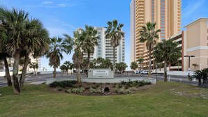 A sign for the Tidewater Condominium with a view of tall buildings and palm trees in the background. - Tidewater 801 | Pools, Gym, Hot Tub, Wifi | Private Balcony | Ocean Front Views (Orange Beach)