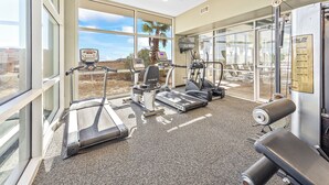 A gym with treadmills, elliptical machines, and a bench. - Tidewater 801 | Pools, Gym, Hot Tub, Wifi | Private Balcony | Ocean Front Views (Orange Beach)