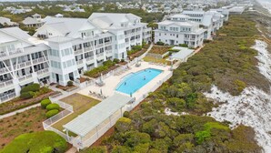 A large resort with multiple buildings, a central pool, and a beach view. - Beach Front + Pool Front Watercolor Condo | Beach Views of 30A (Watercolor)