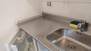 A stainless steel kitchen sink with a built-in dishwasher and a small countertop area. - Bèz Apartment in Milan Tortona street Fashion design district  (Milano)
