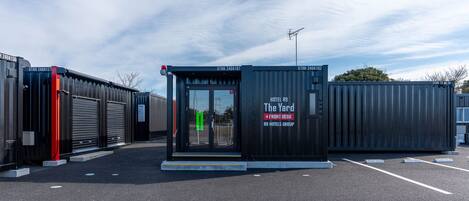 A hotel named "The Yard" with a front desk and a sign indicating it's part of the R9 Hotels Group.